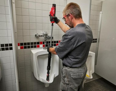 Milwaukee M12 Trapsnake Cordless Urinal Auger Used in Bathroom