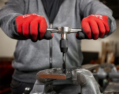 Milwaukee Tool Hand Tap Being Used to Cut Threads in Metal